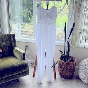 All white jumpsuit. Zipper back with adjustable straps.